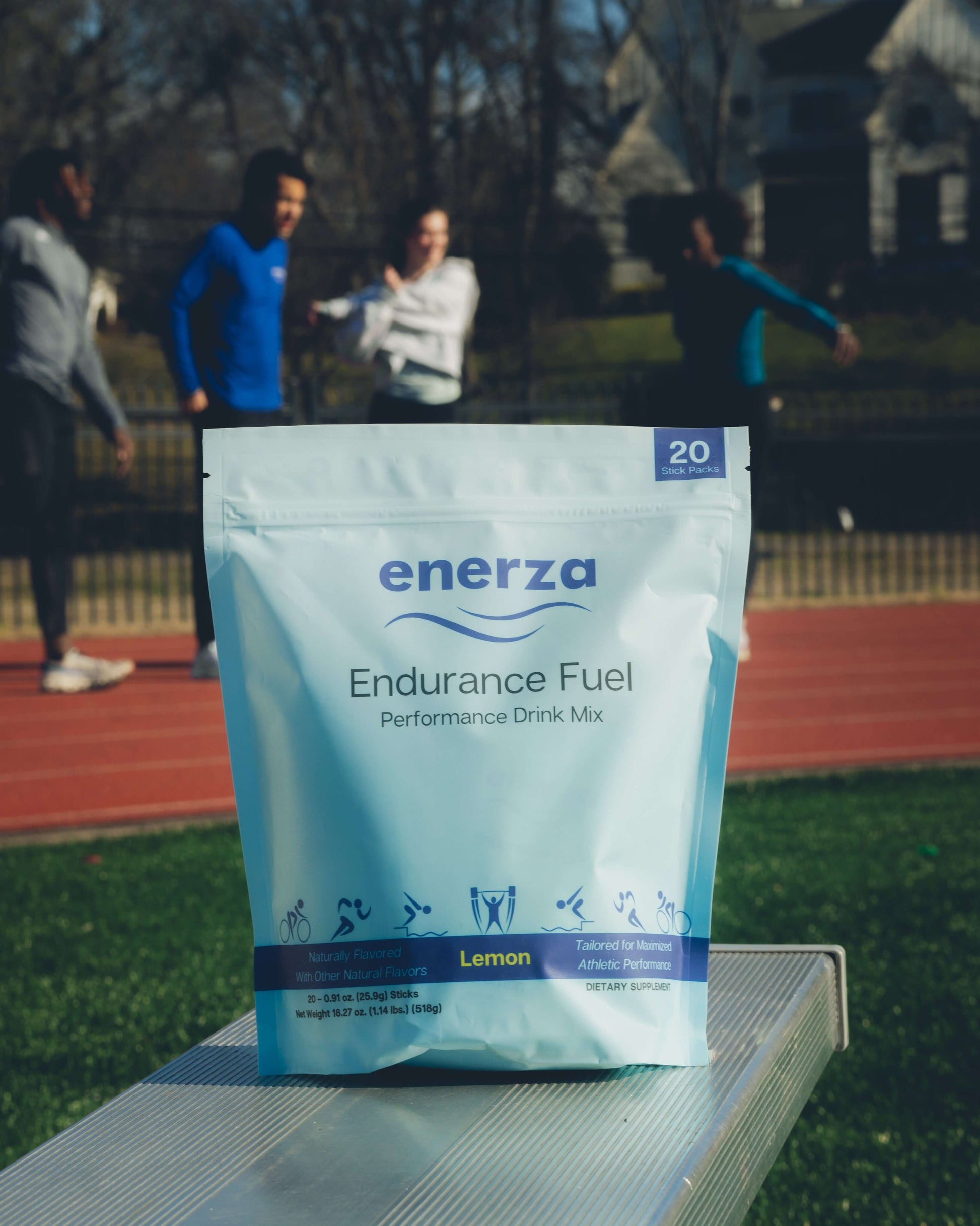 Enerza Endurance Fuel package placed on an outdoor running track, emphasizing the product’s connection to competitive running and endurance performance.